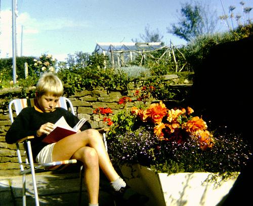 Boy reading in his garden. AndyRobertsPhotos (2013).