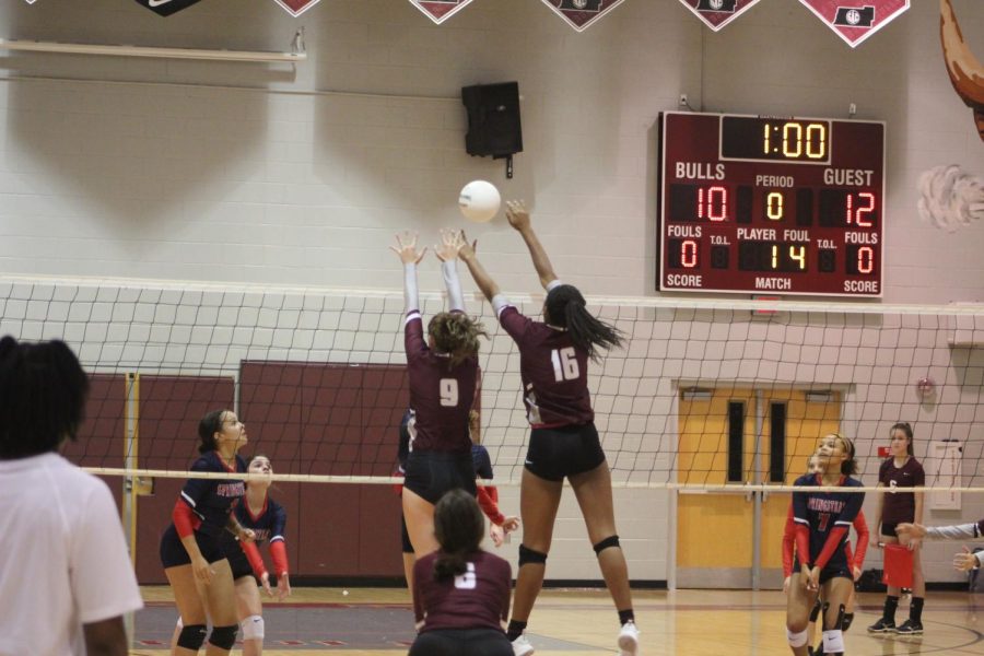 Zoi Evans (16) and Alexis Driggers (18) attempt a block. 
