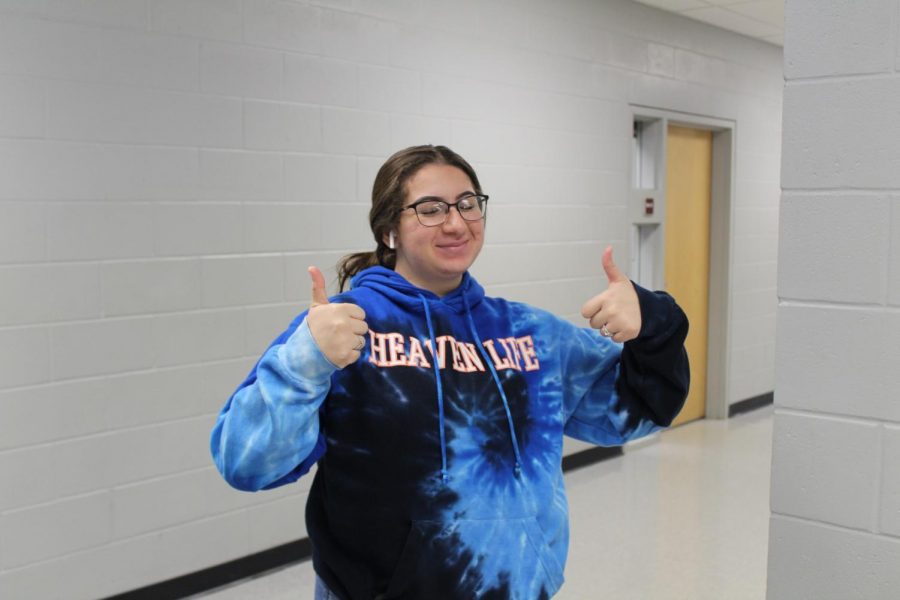 Senior Monica M giving a thumbs up to not giving up her last year