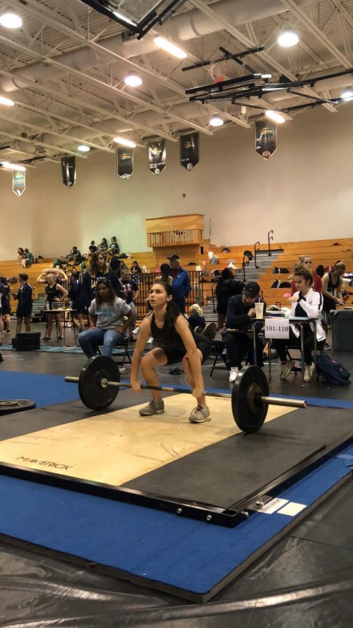 Junior Nicaela Paolinetti performs a clean and jerk. 