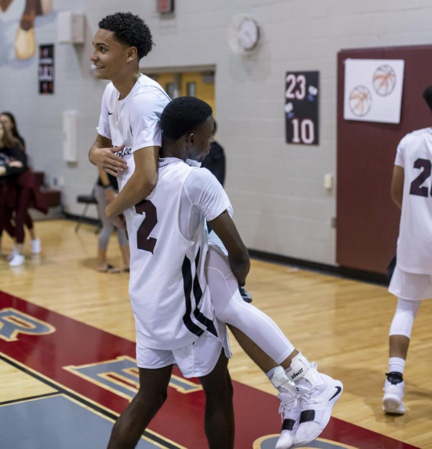 Elijah Howell celebrating his 1,000 point after the game with teammate Brian Parker. 