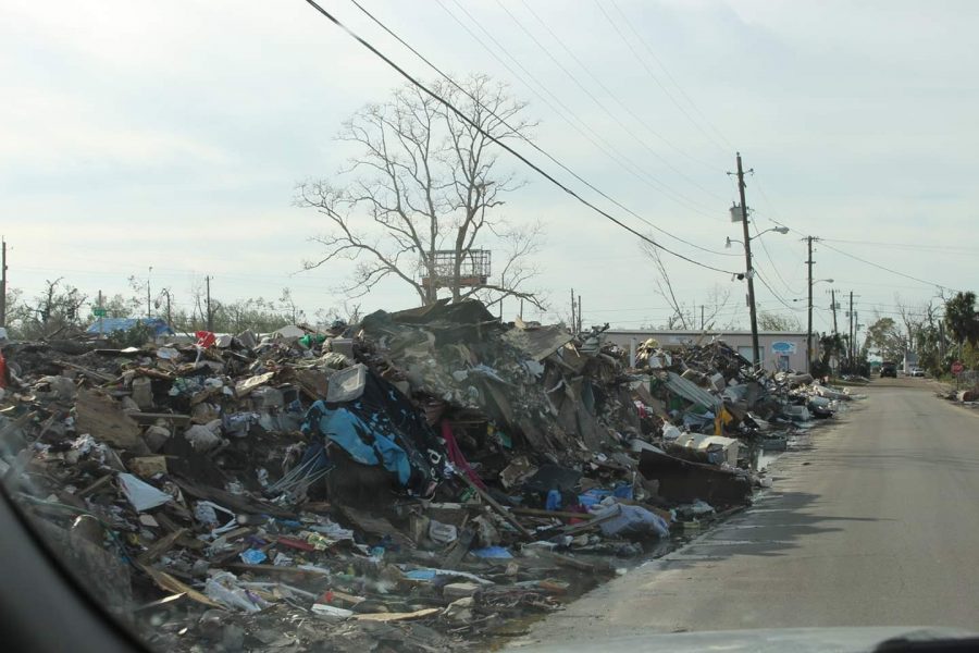 Piled up garbage on the side of the street due to destruction. 