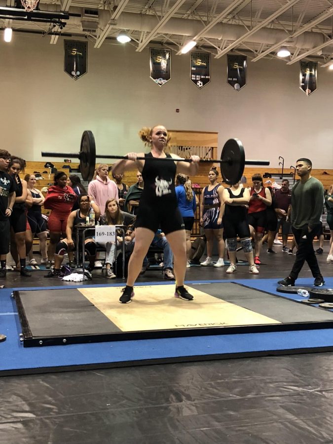 Maridith Baker performing a clean and jerk.