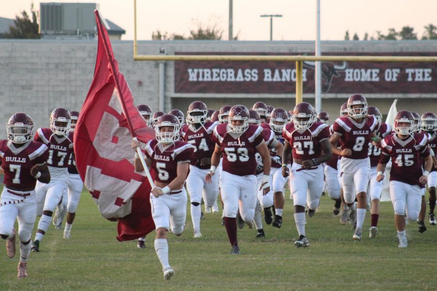 The Bulls charging onto the field to start the game. 