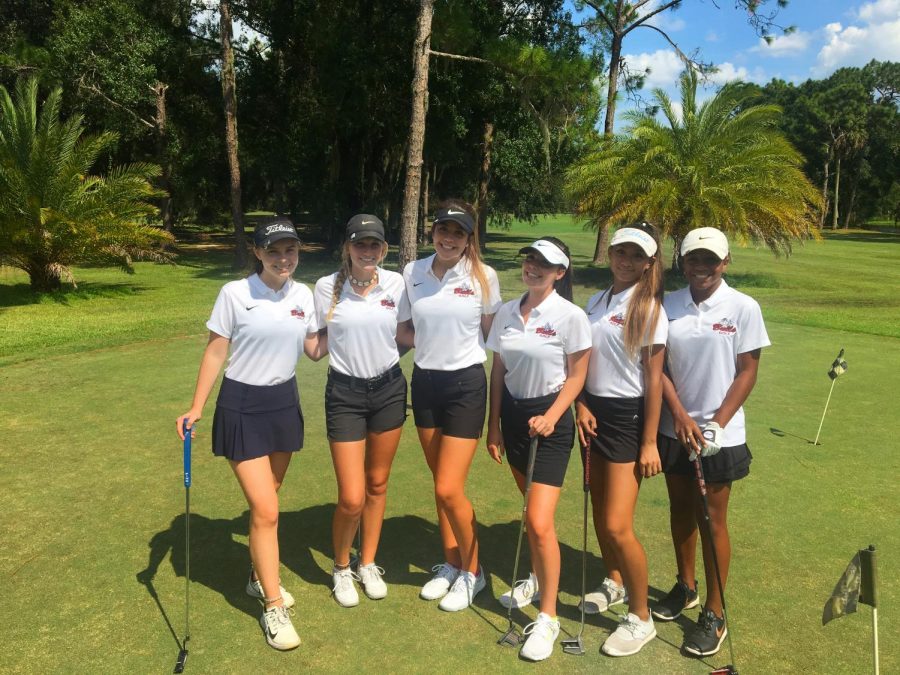 The top 6 players on the girls golf team pose for a photo before their match.