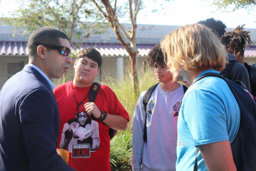 Florent Groberg speaking with a group of students after the presentation.