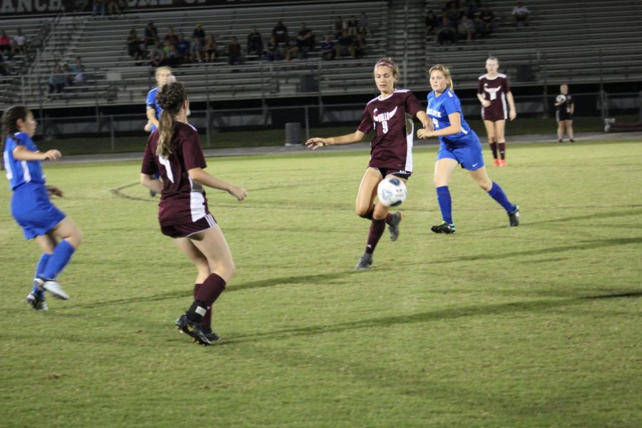 Senior forward Avery Damjanovic keeping possession of the ball away from Anclote. 