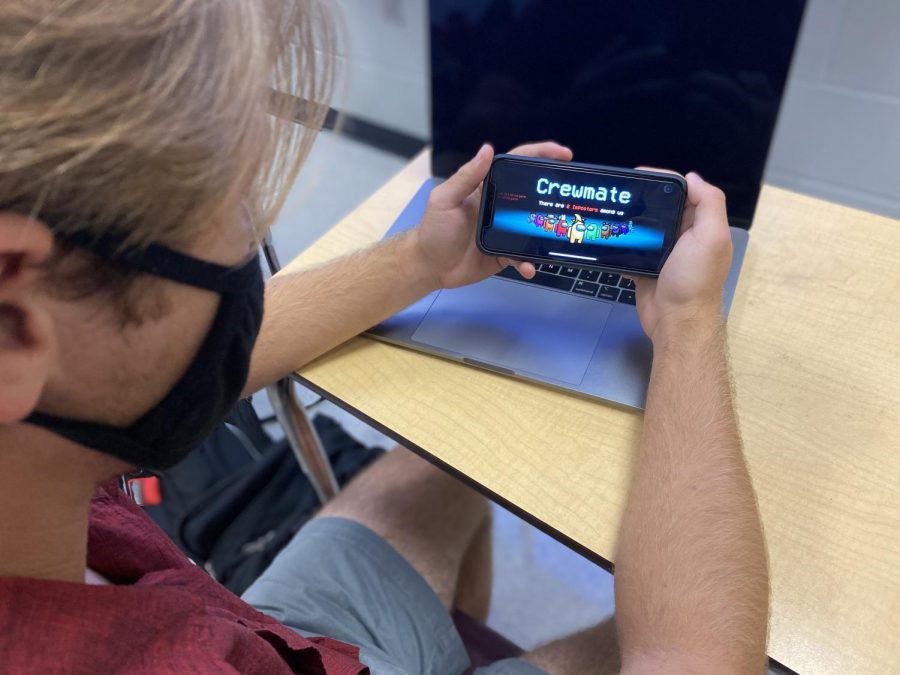 Patrick Amis playing Among Us on his phone before his class period begins.