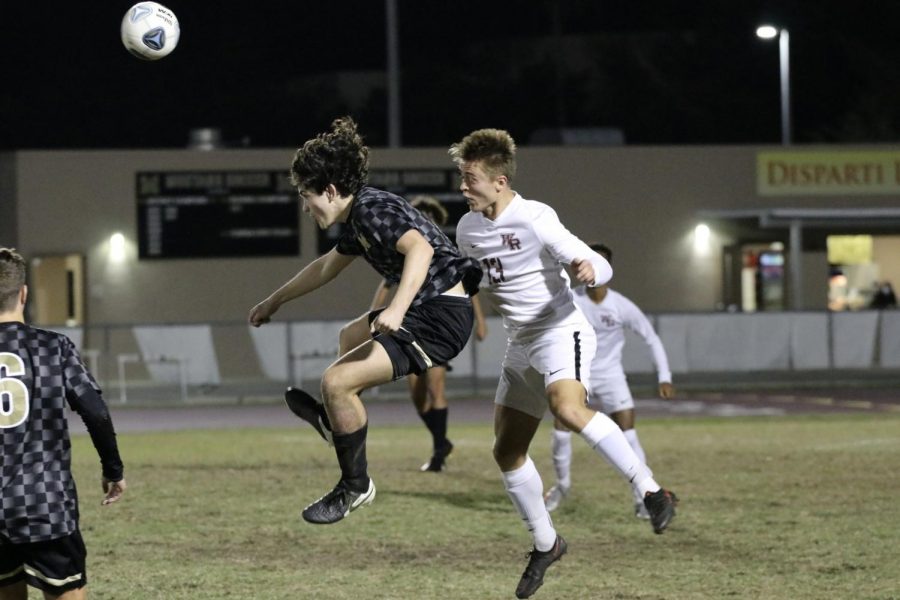 Justin Amis (13), heads the ball for a shot on goal.