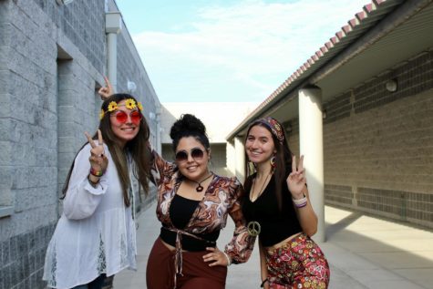Newspaper students Daneila Pena, Isabella Rey, and Nicole Pi pose in their Hippie Day attire.