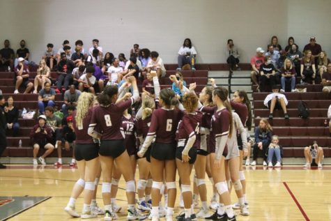 Wiregrass volleyball coming in for a team huddle. 