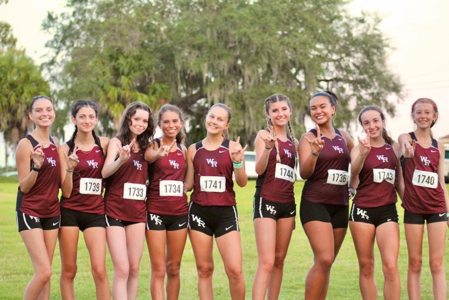 Wiregrass+girls+varsity+pose+for+a+photo+after+placing+8th+in+the+Rogers+Park+Invite.