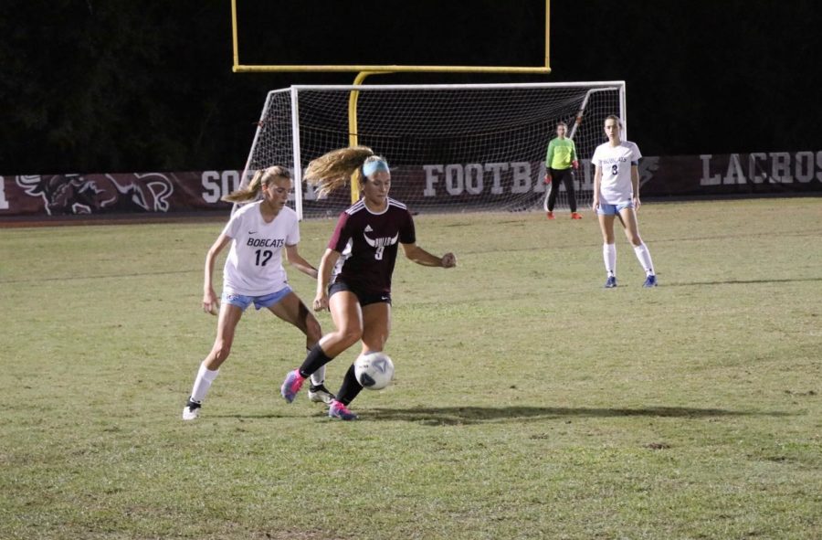 Junior Emily Erker (9), moving the ball up the field. 