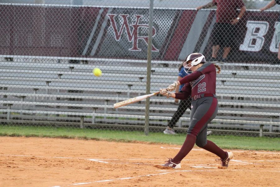 Juliana Snyder hitting the softball.