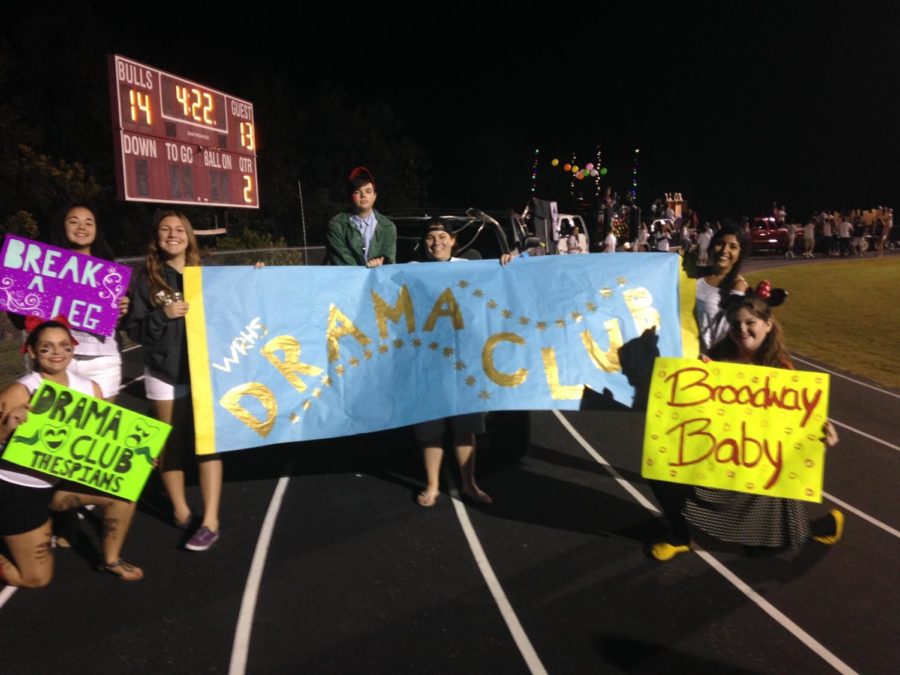 Miss Sheppard (far right), leading her troupe as Drama Club President on Halloween night in 2014.