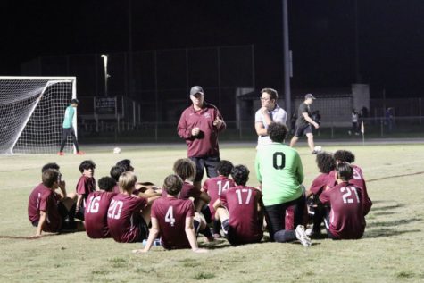 Coach Wilson meeting with his team after the game.