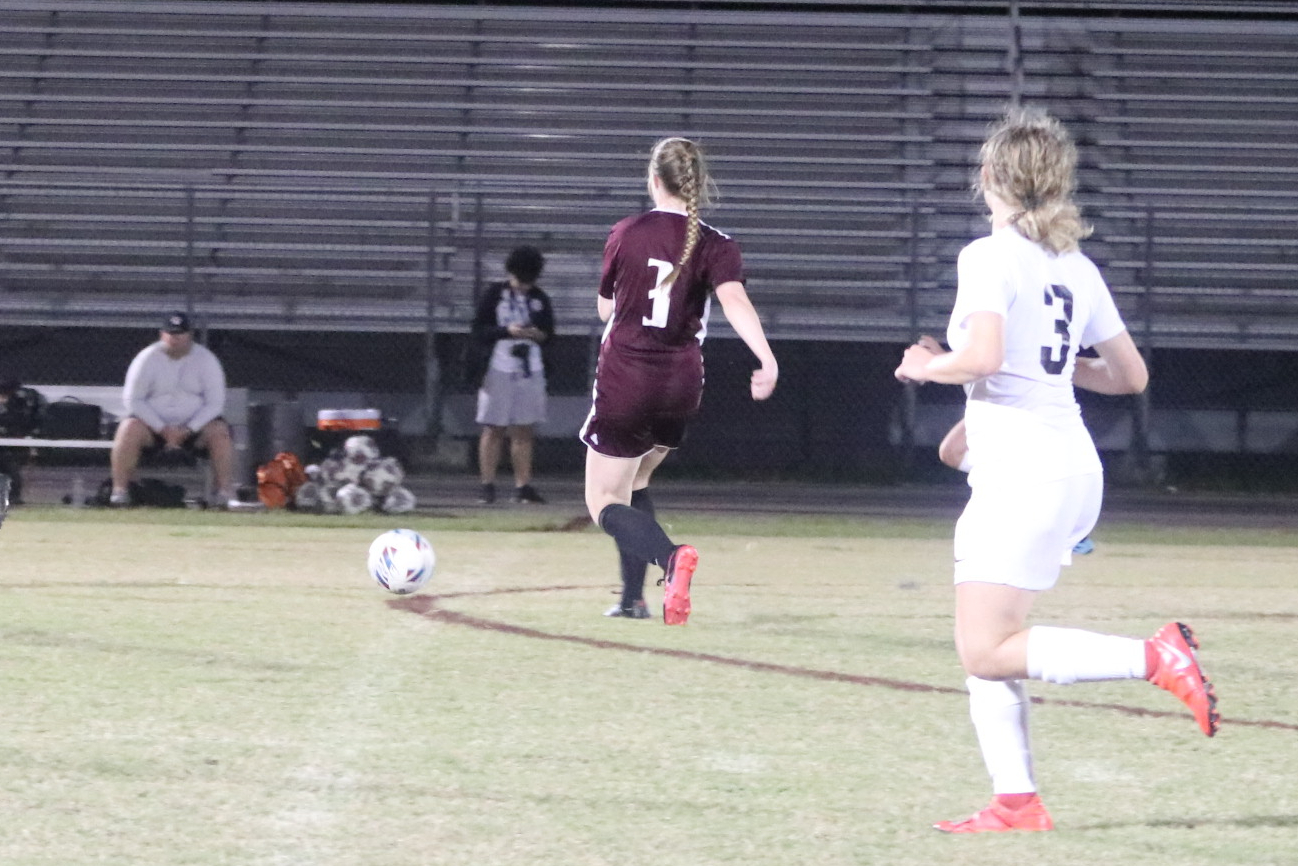 Kylie Bennington, junior, looking to pass to her teammate during the Zephyrhills game.