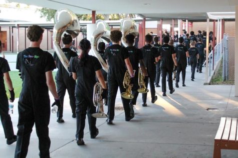 The band travel walks in their twos to the competition field for their performance.