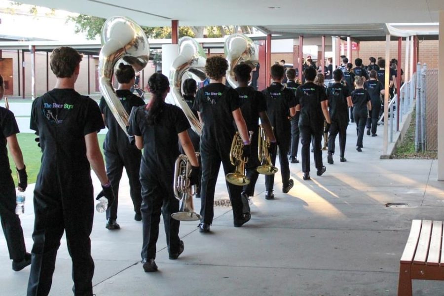 The band travel walks in their "twos" to the competition field for their performance.