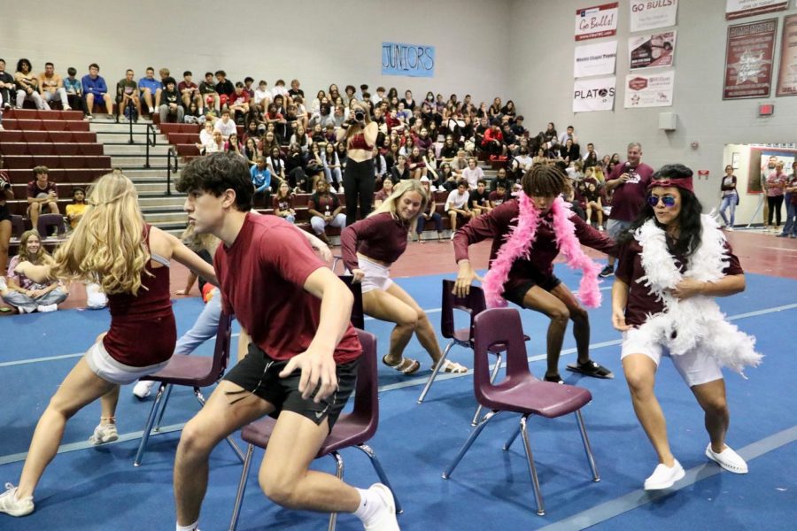 Students and teachers participating in the musical chairs game during the pep rally